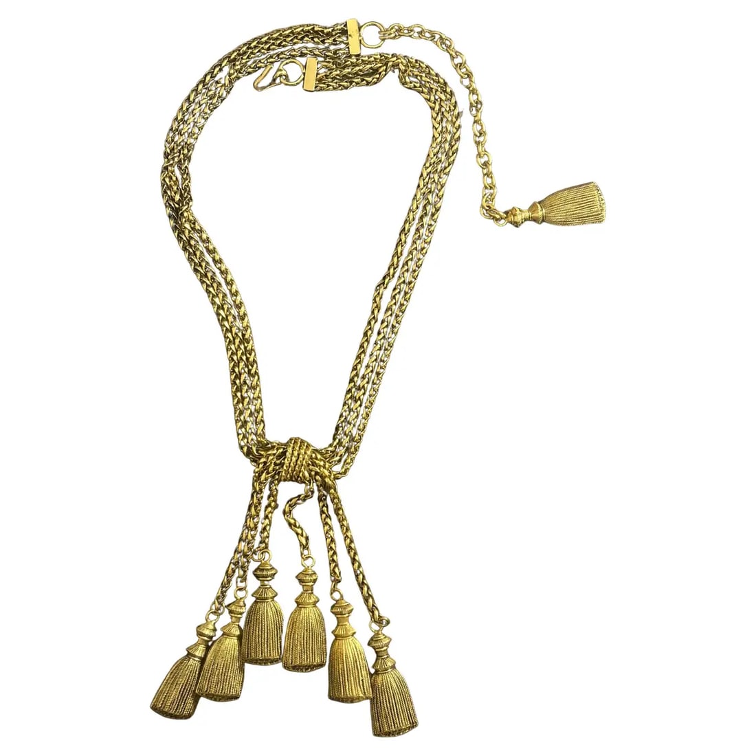 1980s Franco Moschino Gold-Toned Tassel Necklace: Made from gold-toned metal, the necklace features a striking knotted design at its center, from which multiple chains dangle, each ending in intricately detailed tassels. The tassels are crafted to mi
