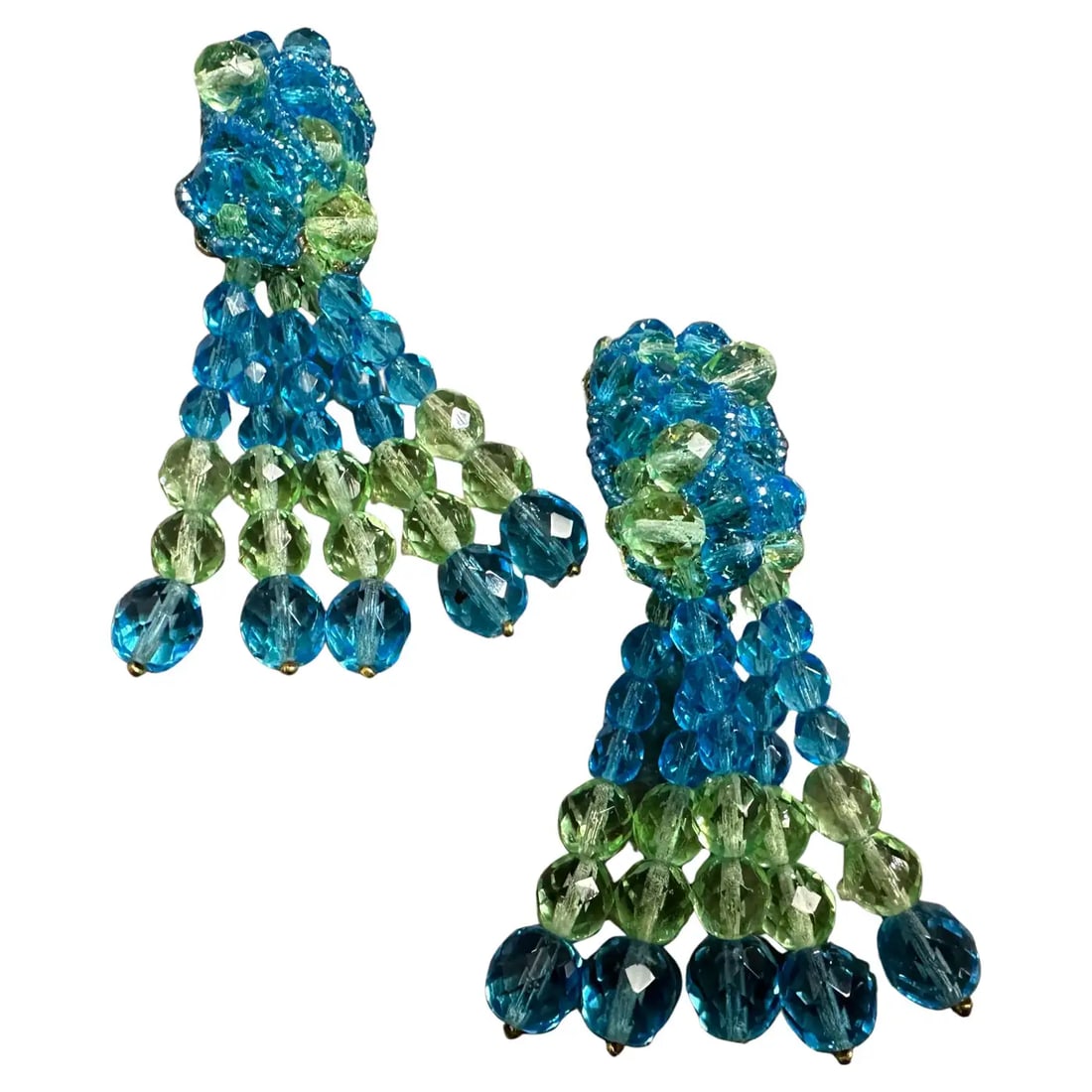 Iconic 21st Century Classic Blue and Green Crystal Chandelier Earrings: These statement earrings feature a bold tassel structure made from meticulously hand-strung beads in contrasting light blue and green tones. The top of the earrings showcases a rounded floral-like mot