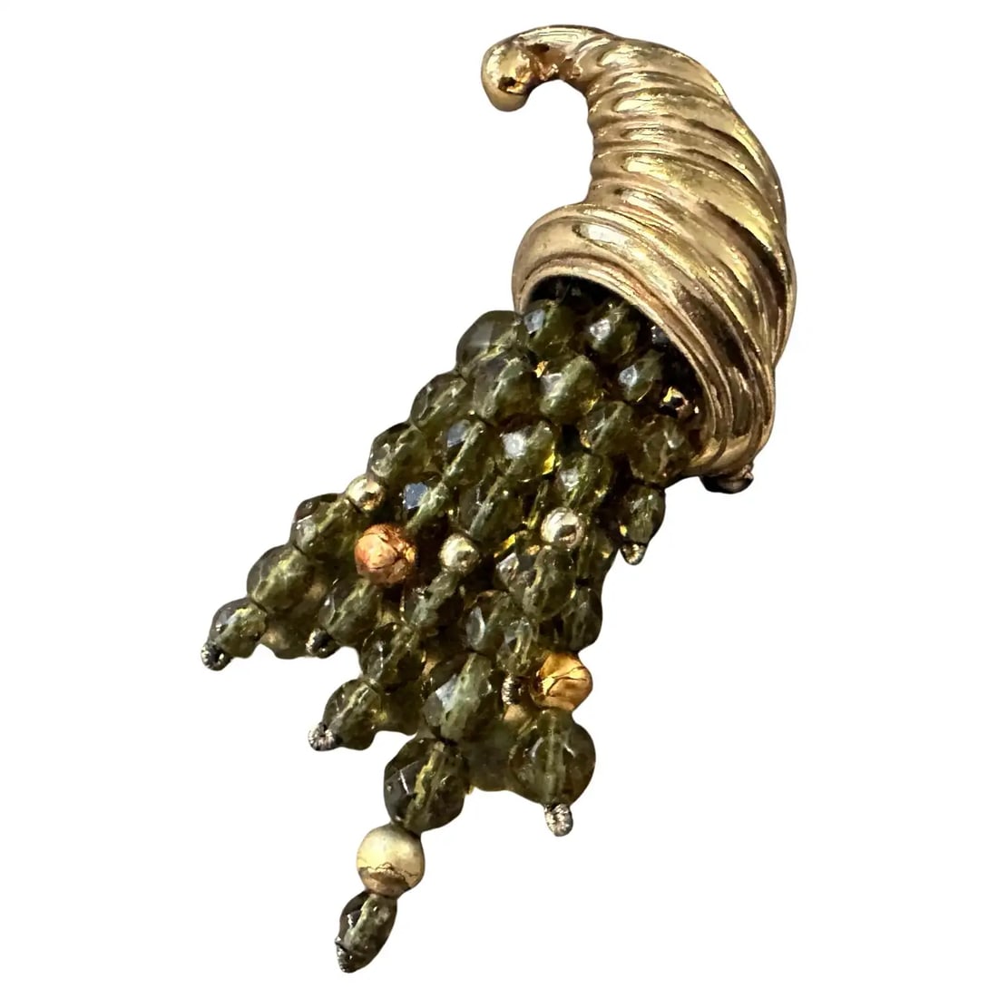 1980s Vintage Costume Jewelry Cornucopia Brooch by Valentino: This stunning 1980s vintage costume jewelry brooch by Valentino is a true statement piece, masterfully crafted in the shape of a cornucopia overflowing with richly colored glass beads. The horn, rende