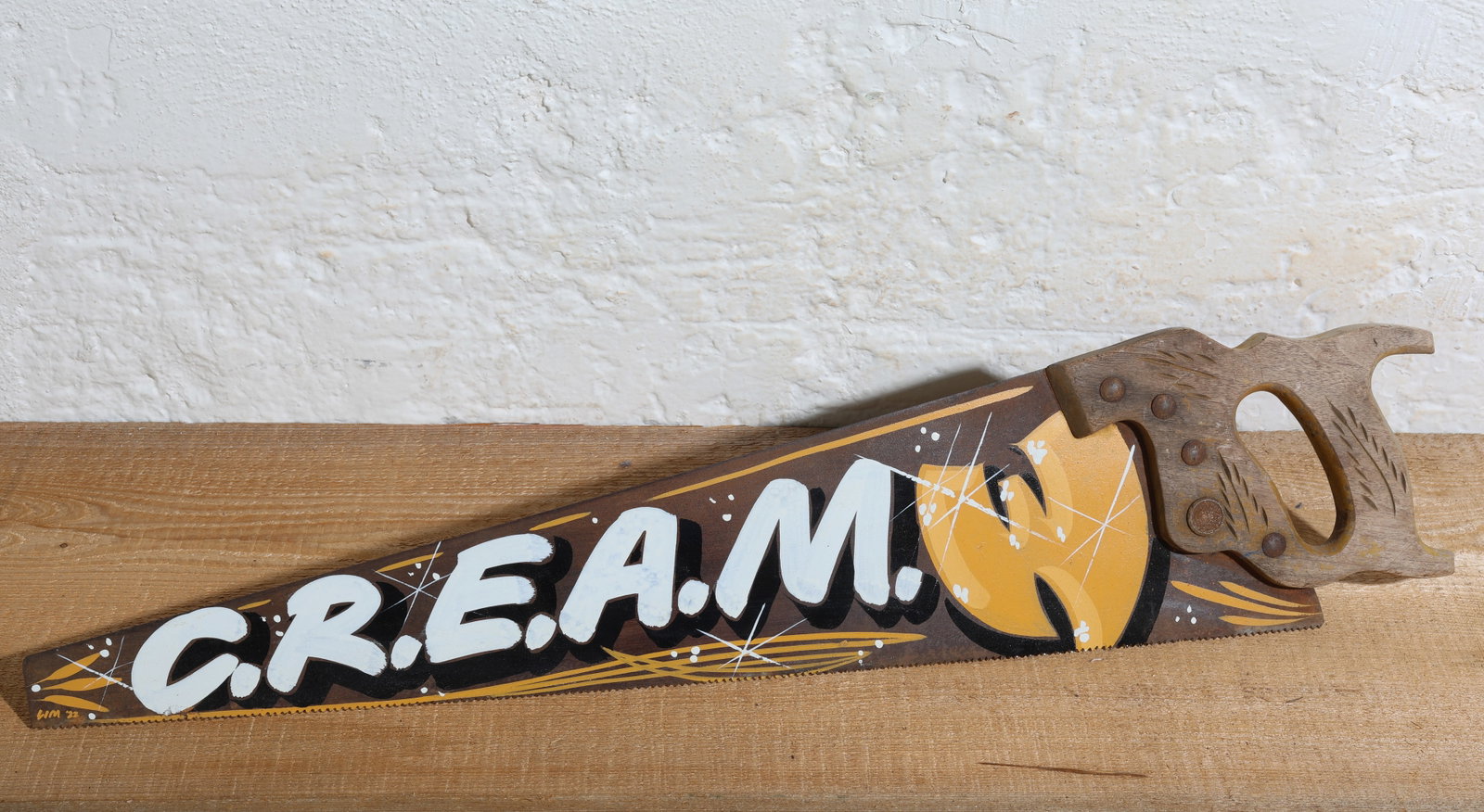 Hand-Painted C.R.E.A.M. Saw: Wu-Tang Clan Inspired Hand-Painted C.R.E.A.M. Saw by Indiana Artist Justin G. Lim (old5anddimesignco). Size: 29'' x 6.5'' (74 x 17 cm).