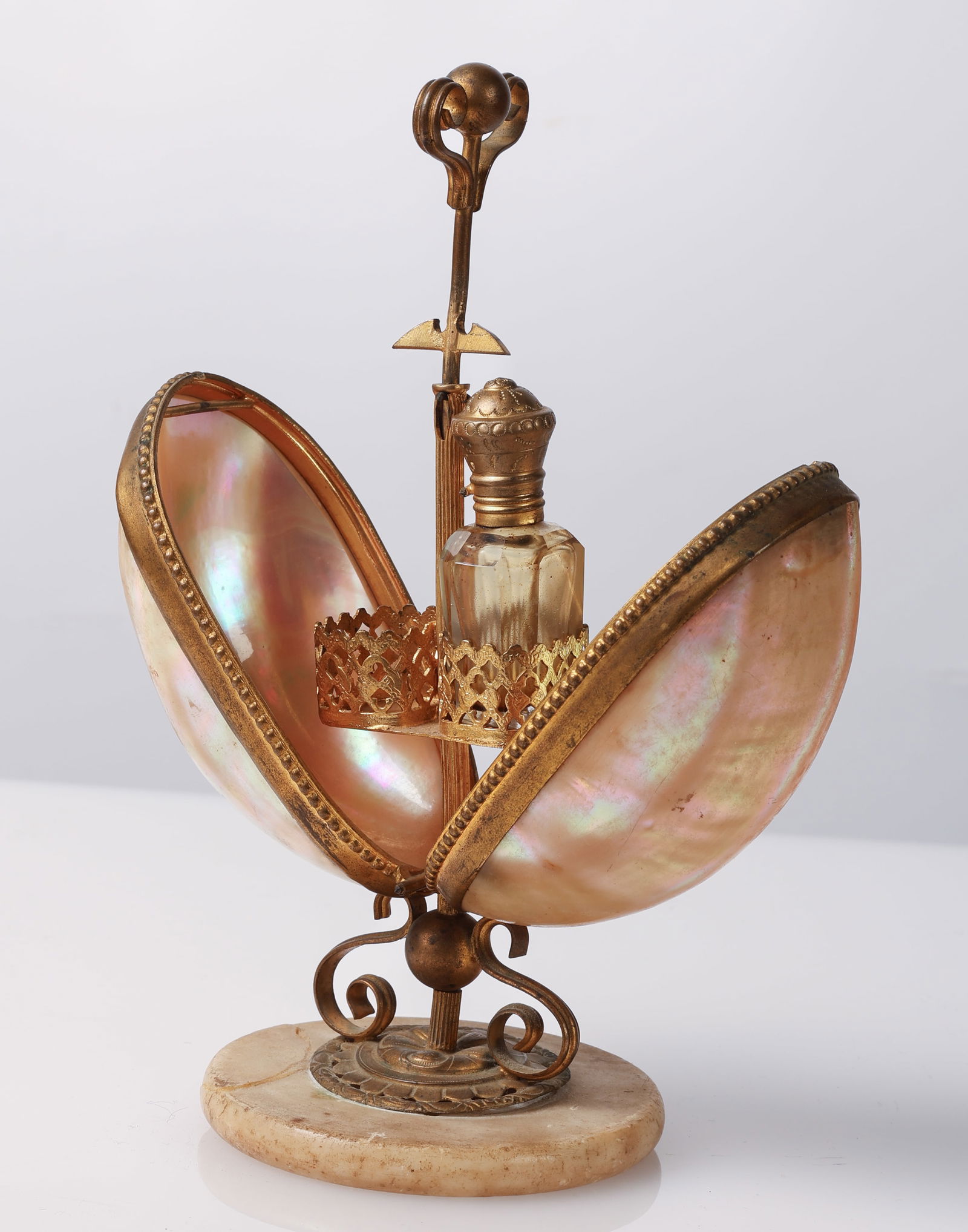 Antique Boudoir Mother of Pearl & Ormolu Egg: Antique Boudoir Decor Mother of Pearl & Ormolu Egg with Hidden Perfume Bottle on marble base. Note: One bottle only; repair to base. Open Size: 7.25'' x 5.25'' (18 x 13 cm). Closed Size: 3'' (8 cm).