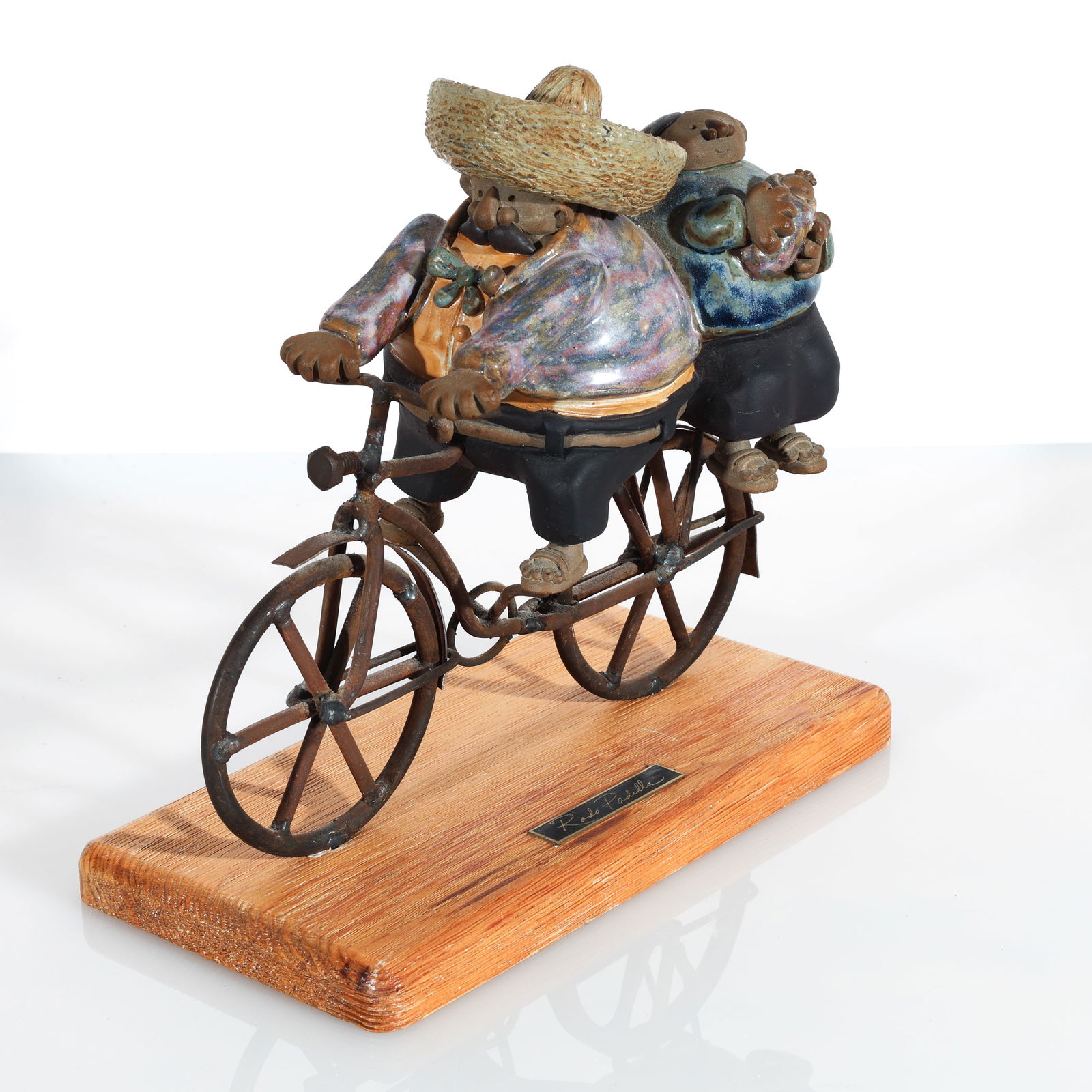 Rodo Padilla (Mexican) Bicyclist: Rodo Padilla (Mexican) Bicyclist Figurine Mixed Media Ceramic Sculpture on wood base. Overall Size: 9.5'' x 9'' x 5'' (24 x 23 x 13 cm).