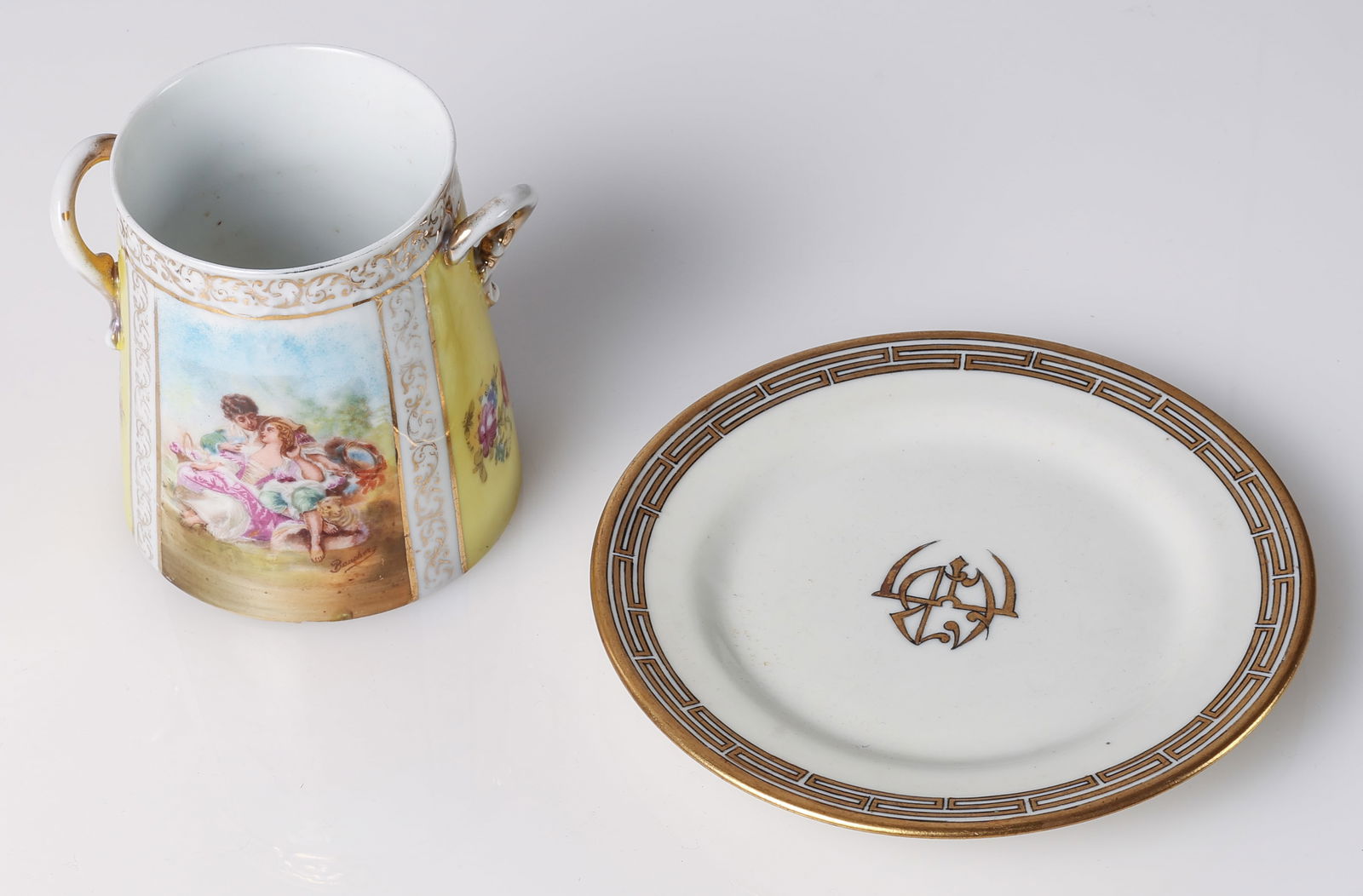 (2 pc) Estate Porcelain: (2 pc) Estate Porcelain: 1) Two-handled cup and saucer with yellow ground, hand-painted pastoral scene signed Boucher, gilt handles and scroll borders marked Austria. Size: 3.75'' x 4'' x 3.5'' (10 x