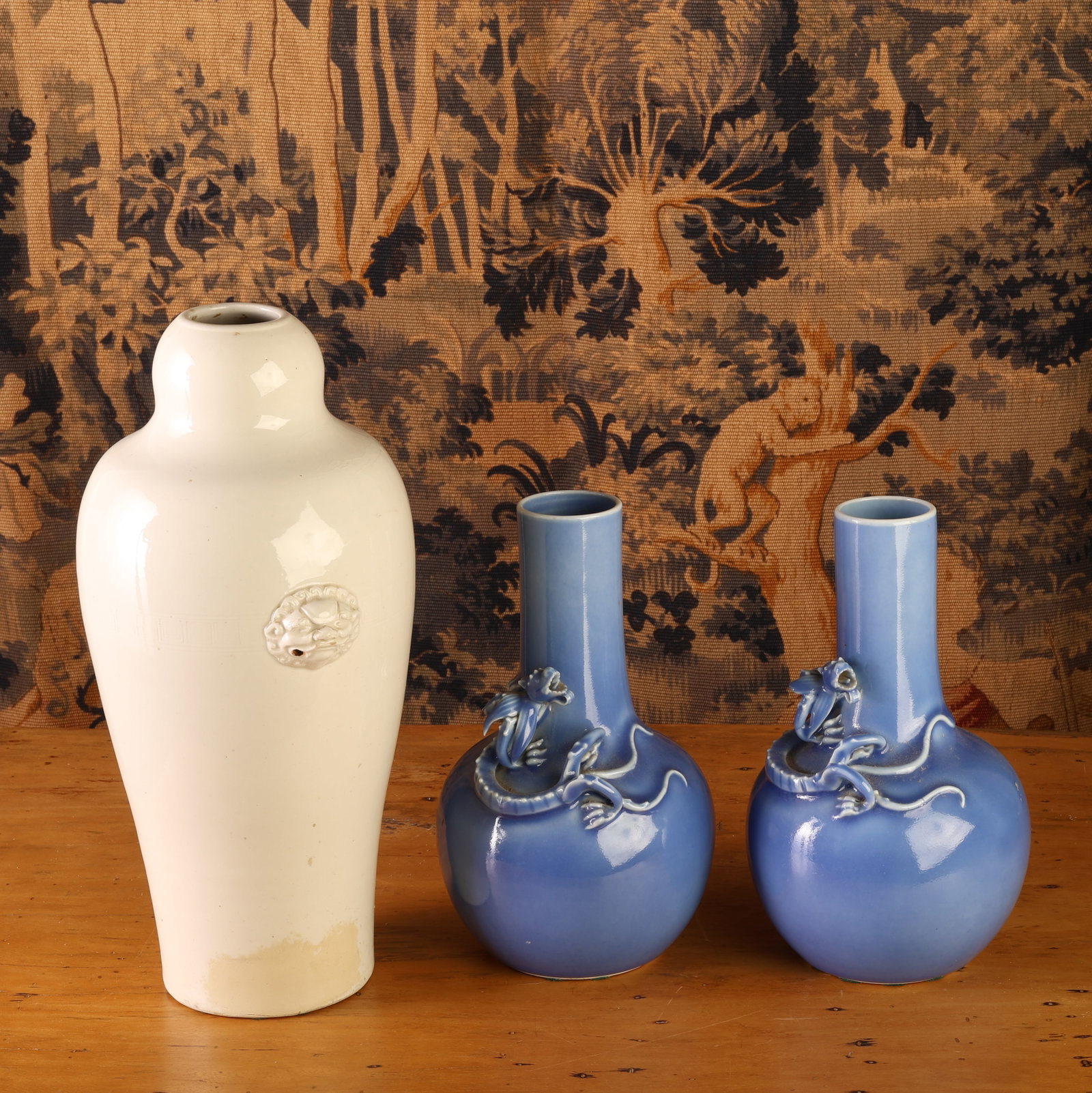 (3) Chinese Vases: (3) Chinese Vases: A pair of claire-de-lune bottle vases. Each size: 7.5'' x 4.75'' x 4.75'' (19 x 12 x 12 cm) and a Blanc de Chine Vase with mythical-beast. Size: 11.5'' x 6'' x 6'' (29 x 15 x 15 cm)