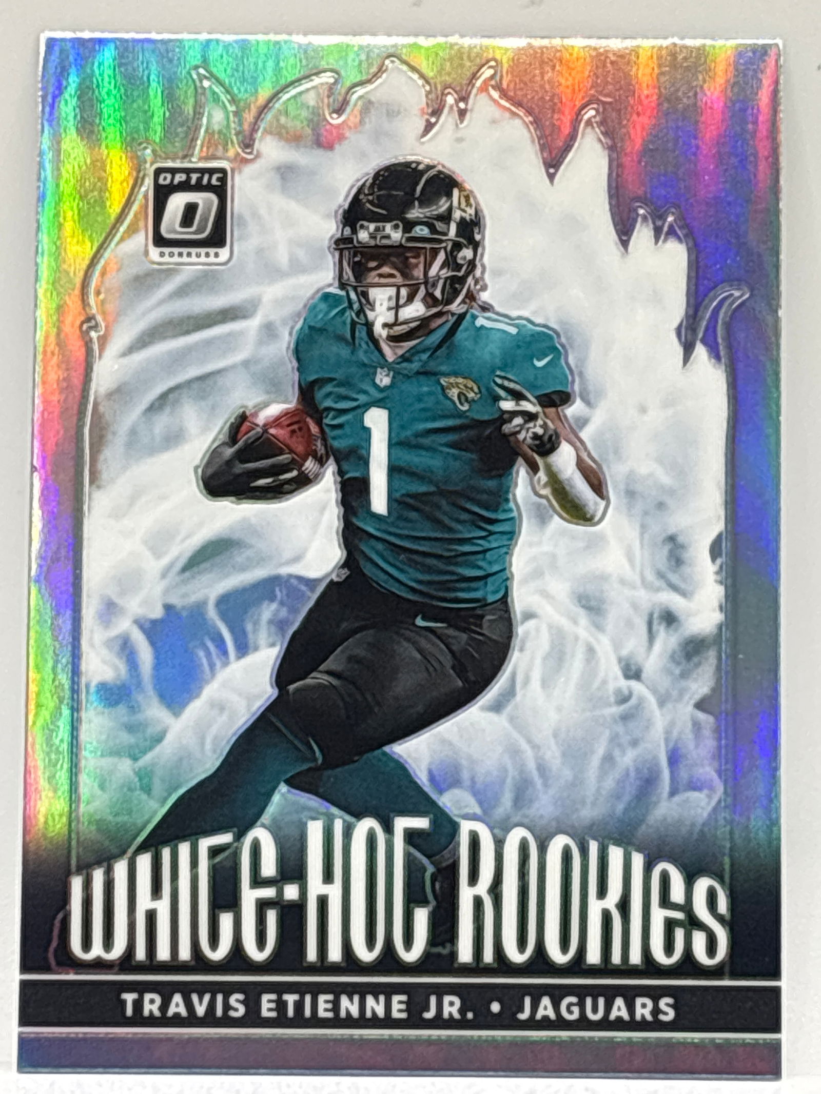 2021 PANINI DONRUSS OPTIC TRAVIS ETIENNE JR WHITE HOT ROOKIES PRIZM HOLO ROOKIE CARD (1 of 4)