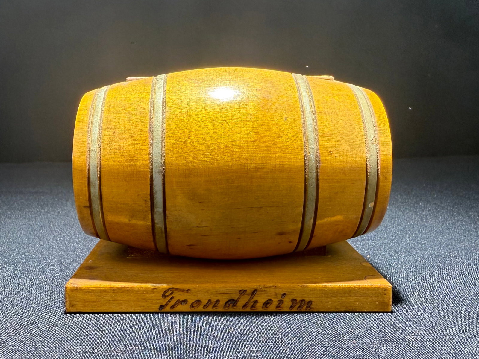Trendheim Wooden Barrel-Form Cigarette Dispenser, c.1950s, No. 26109: Distinctive mid-century cigarette dispenser crafted in the form of a miniature barrel, featuring banding details on a honey-colored wooden body. Made by Trendheim (marked on base and stand), this well