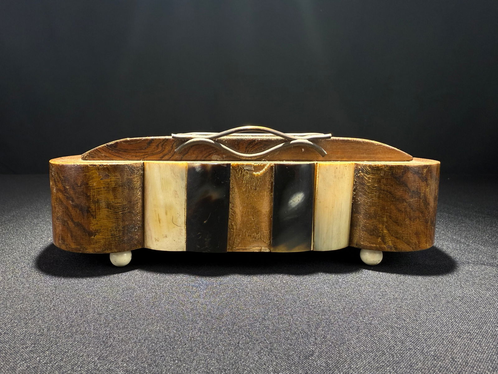 Musical Cigarette Box with Inlay, circa 1940s: A sophisticated wooden cigarette box featuring alternating inlay stripes, with an integrated music box mechanism. This mid-century tobacciana piece includes a tiered cigarette display rack when opened