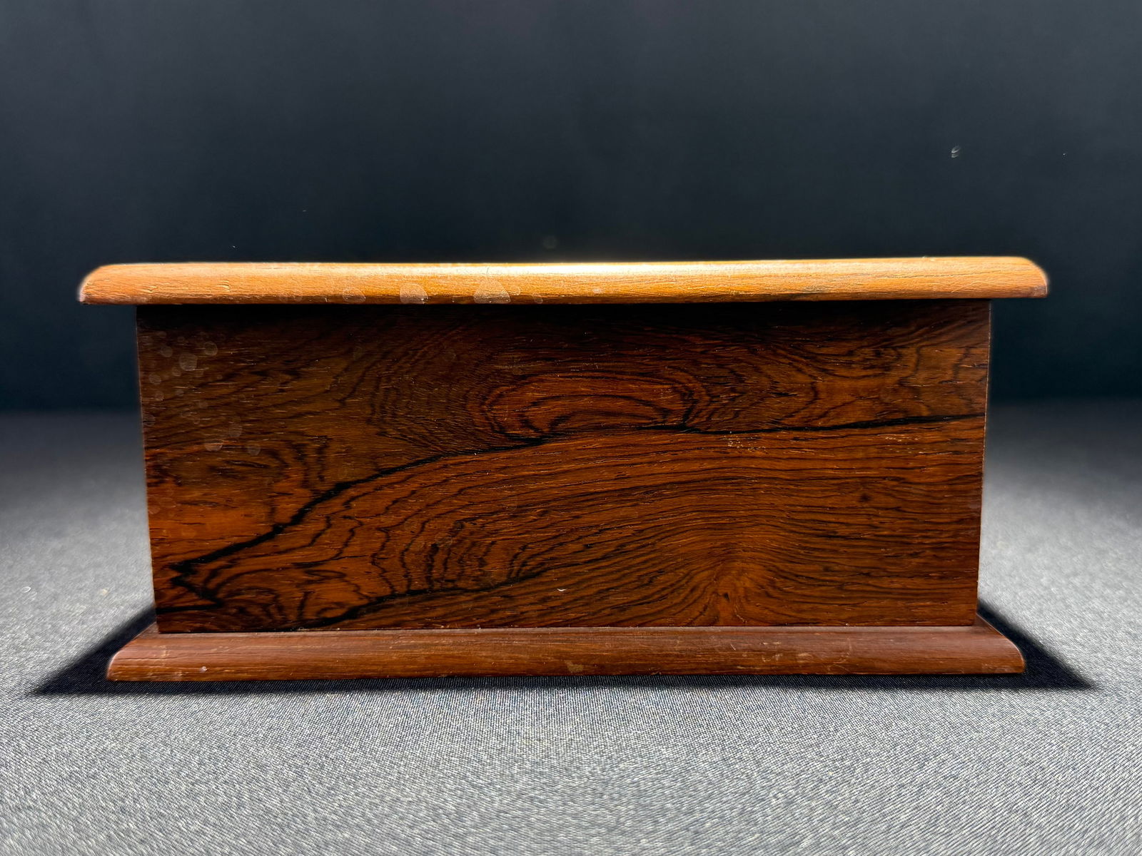Wooden Cigarette Box with South America Inlay Design, circa 1940s: A handsome wooden cigarette box featuring an inlaid design of South America on the lid. The box opens to reveal a well-crafted interior with four-tiered cigarette storage compartments, accommodating 4