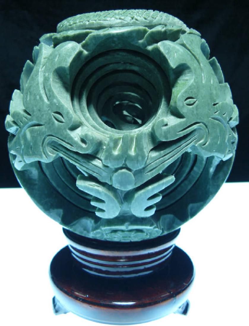 LARGE JADE 8 LAYER DRAGON PUZZLE BALL SPHERE: THIS WONDERFUL PIECE OF WORK IS MADE OF REAL JADE. IN ONE PIECE OF SOLID JADE, THERE ARE TOTAL OF 7 BALLS INSIDE. ALL BALLS INSIDE ARE MOVABLE INDIVIDUALLY. IT COMES WITH A WOODEN BASE. Size: Wide: 6"