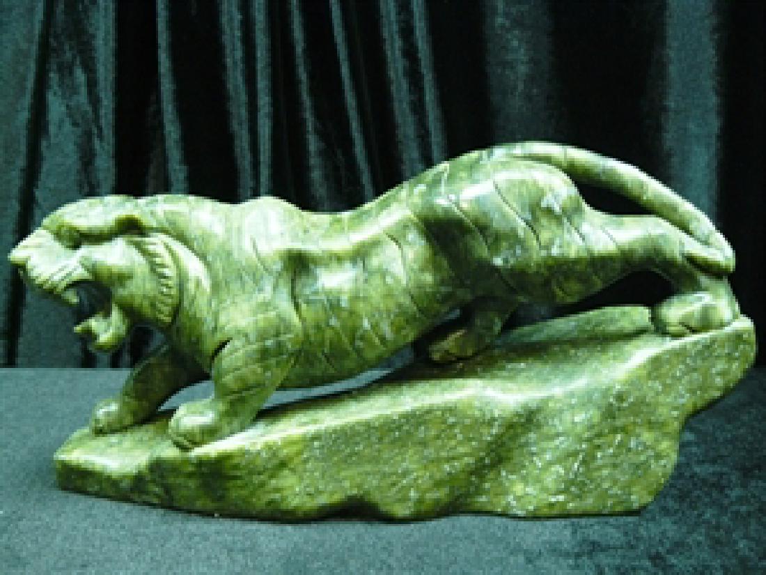 Green Jade Running Tiger: SIZE: LONG 12", DEEP 3", HIGH: 6.5". This jade tiger is made from one solid piece of jade. It appears dark gree. It is all hand carved. Very detailed.