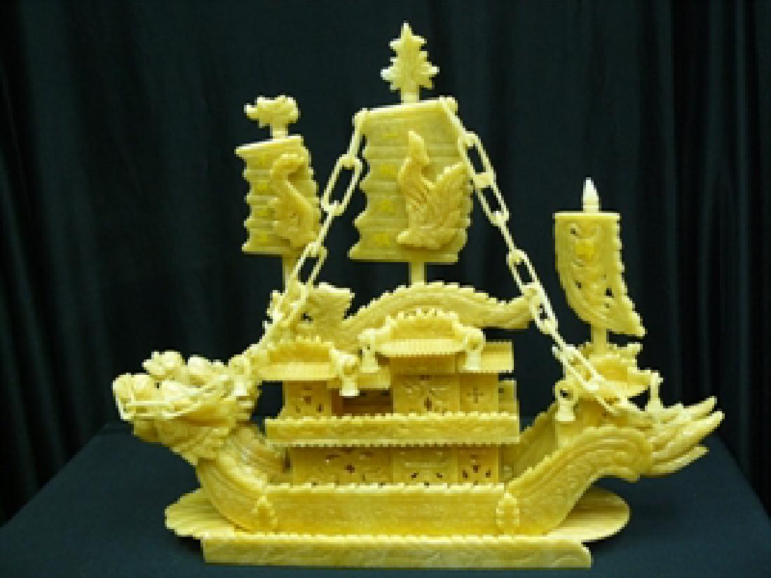 24" YELLOW JADE DRAGON BOAT: This boat is made from natural yellow jade. It is all hand carved. It consists of boat body, parts and wooden base. There are 2 dragons on the boat. Very detailed carving. LENGTH: 24", HEIGHT: 20", WI