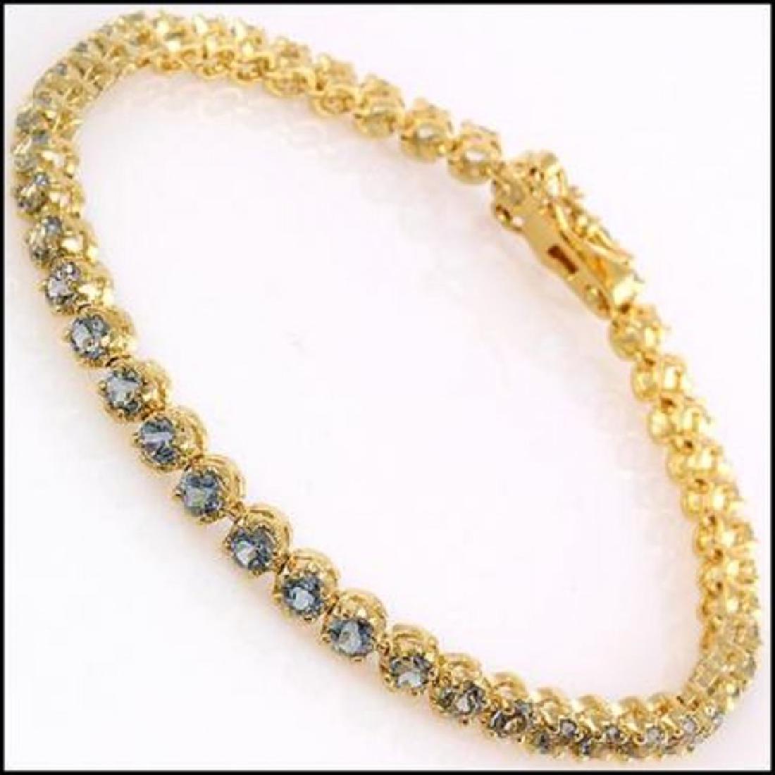 10.22 CT Blue Topaz Tennis Fine Bracelet $1120: Master jewelers designed your bracelet with: 45 pieces of GENUINE 4mm faceted Topaz quality AAA no treatment. 12.12 grams of sterling silver layered with 18K yellow gold (18KGP). The length is around 