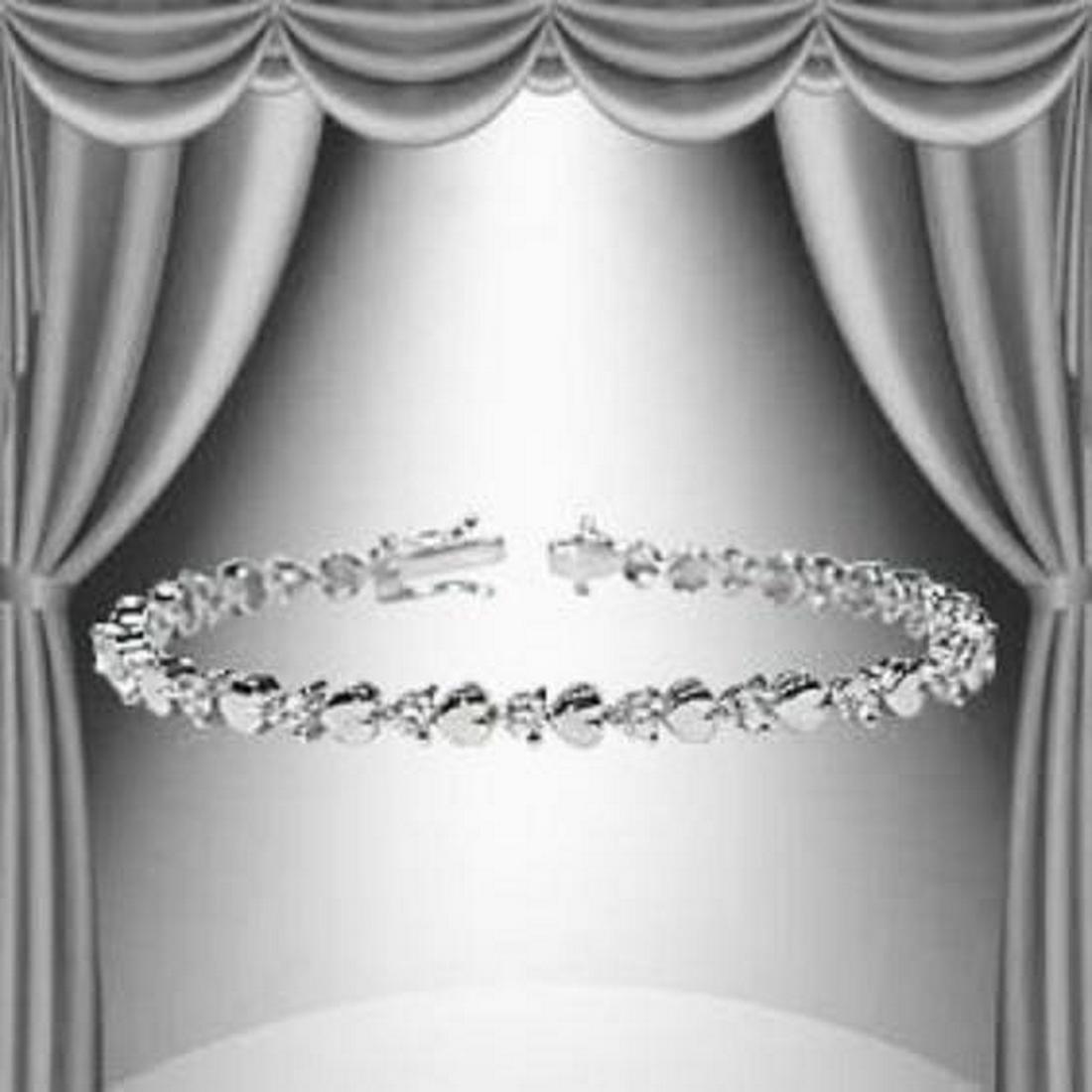 1.23 CTW Diamond and Hearts Silver Tennis Bracelet: Master jewelers designed your bracelet with 21 single cut diamonds 1.23 carat tw. 11.4 grams of sterling silver layered with 18K White Gold. Length is 7 1/2 inches.