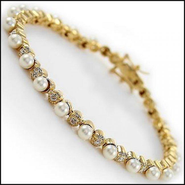 8.07 CT Freshwater Pearl & Diamond Designer Bracelet: 23 pieces of 2.4-2.7mm freshwater pearls no treatment quality AAA. 3 pieces of single cut diamonds, no treatment quality I2-I3 .10.62 grams of base metal layered with 18K yellow gold.The length is 7 1