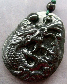 200 Carat Black Green Jade Fish Dragon Amulet: The Royal Cameo Carving Jade Charm was carved from a piece of fine grained Jade gemstone more than 200 years ago. The design is unique and very lovely and the carving is delicately performed. • •S