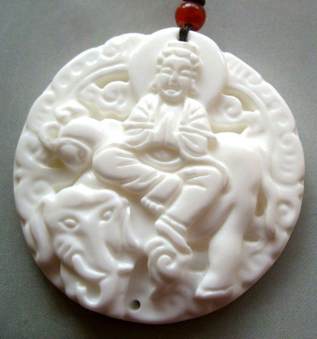 Natural Sea Shell Buddhist Pu-Sa Elephant Amulet Pe: Natural Sea Shell Buddhist Pu-Sa Elephant Amulet Pendant, intricately carved from a natural sea shell. Size: 47mm x 47mm.