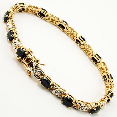 12.09 CT Sapphire & Diamond Designer Bracelet $1,350: 12 pieces of GENUINE 7X5mm oval black sapphires.12 pieces of GENUINE single cut diamonds, 0.09 carat tw.12.25 grams of brass layered with 18K yellow gold.The length is around 7 1/2 inches.The width is