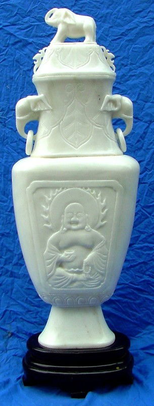 Hand Crafted White Jade Elephant Head Vase: This vase is made from white jade, all hand carved from natural stone. It appears pure white in color with some areas grey. The lid can be removed. An elehant is carved on top. A buddha is carved on t