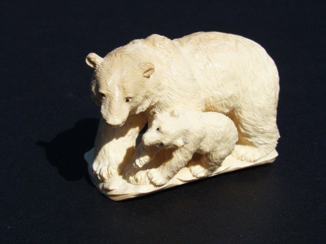 Rare Hand Carved Ivory Figurine Polar Bear and Cub: This beautiful art is all hand carved from natural Mammoth Ivory. Size 2" x 1.5". About the Mammoth Ivory: Mammoth Ivory is a hard, white, organic substance that is the bulk of the teeth and tusks of 