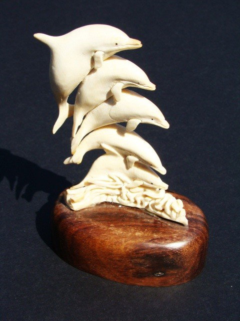 Rare Hand Carved Ivory Figurine 4 Dolphins: This beautiful art is all hand carved from natural Mammoth Ivory. Size 3.5" x 2.5". About the Mammoth Ivory: Mammoth Ivory is a hard, white, organic substance that is the bulk of the teeth and tusks o