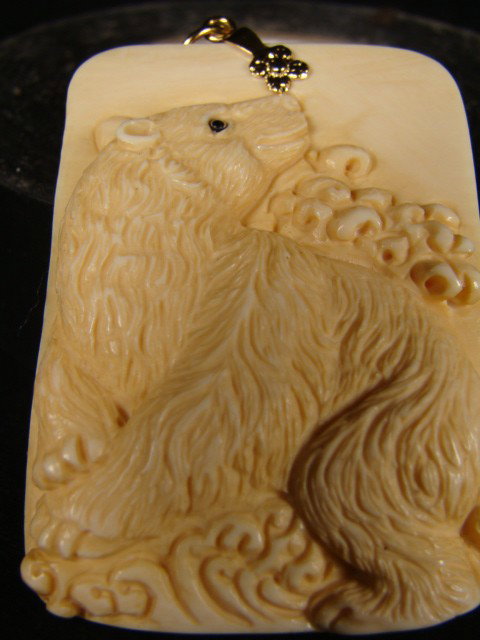 Rare Hand Carved Ivory Polar Bear Bath Pendant: This beautiful art is all hand carved from natural Mammoth Ivory. This is an intricate carving depicting a polar bear enjoying his bath amongst the waves taken from chinese folklore. It is rare and un