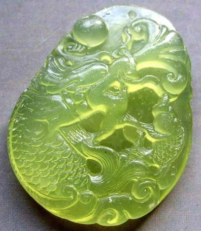 Chinese Green Jade Dragon Fish Amulet Pendant: The Royal Cameo Carving Jade Charm was carved from a piece of fine grained Jade gemstone more than 200 years ago. The design is unique and very lovely and the carving is delicately performed. • •C