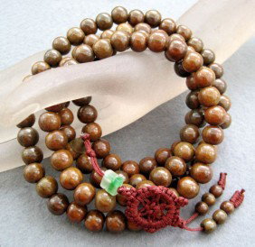 108 Sandalwood Beads Buddhist Prayer Mala: This is a set of wooden prayer beads. They are normally used for both prayer and meditation. This set of Tibetan prayer beads was handmade. Beads Size: 10mm