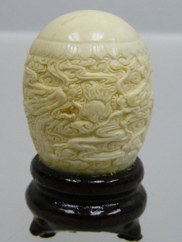 Hand Carved Bone Dragon Egg : This Dragon Egg is made from cow bones. All natural and all hand carved from natural cow bone. It is not bone powder, resin or mouded. Very detailed carving. SIZE(with wood stand): Wide: 1.5", Deep: 1