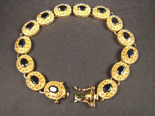 Genuine 7 CT Sapphire Bracelet: Master jewelers handcrafted this bracelet with 13 pieces of 6mm x 4mm oval genuine Garnet . The stones are set in 21 grams of sterling silver layered with 18K gold plated. The length of the bracelet i