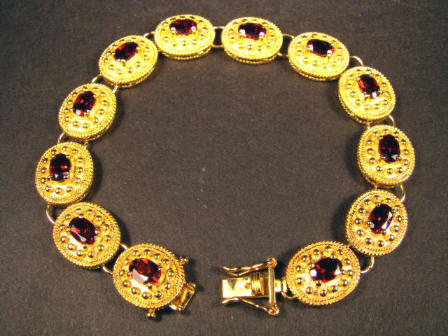 Genuine 7 CT Garnet Bracelet: Master jewelers handcrafted this bracelet with 12 pieces of 6mm x 4mm oval genuine Garnet . The stones are set in 21 grams of sterling silver layered with 18K gold plated. The length of the bracelet i