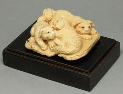 Handcrafted Mammoth Ivory Figurine Playing Dogs: 100% Genuine Mammoth ivory handcrafted "Three Playing Dogs" carving, size: 2-5/16" x 2" x 1-1/16" (59mm x 51mm x 27mm). This carving is carved from the mammoth ivory tusk with with some age cracks and