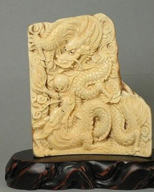 Handcrafted Mammoth Ivory Double Dragons with Ball: 100% Genuine Mammoth ivory handcrafted "Double Dragon With Ball" carving, size: 4" x 3-3/8" x 3/8" (102mm x 86mm x 9mm). This carving is carved from the mammoth ivory tusk with with some age cracks an