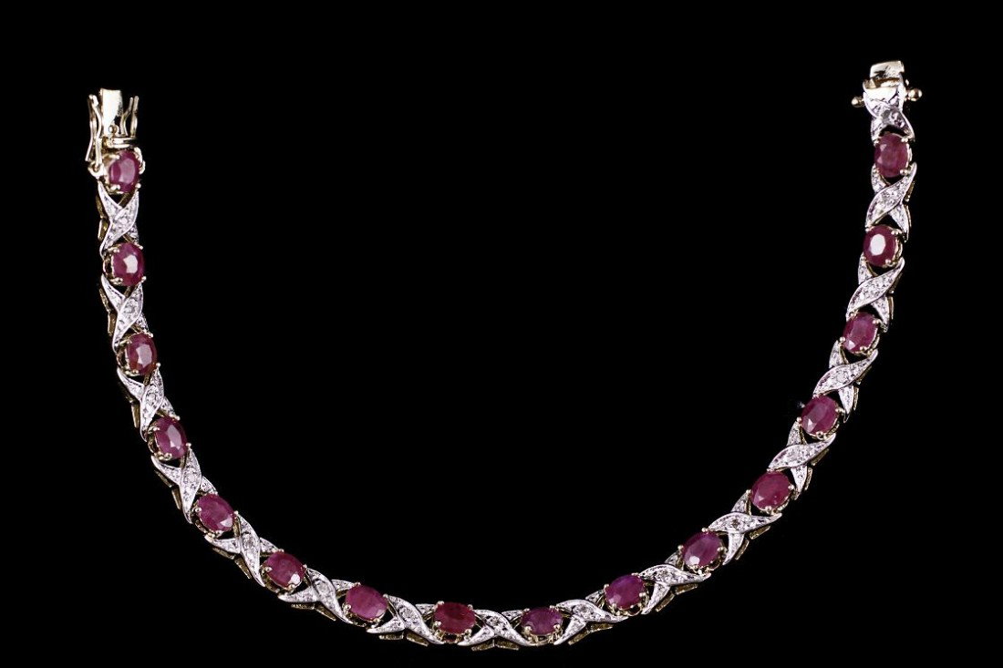 Genuine 8 CT Cabochon Ruby Diamond Bracelet: Master jewelers designed your bracelet with. 16 pieces of GENUINE 5X4mm oval GENUINE Cabochon ruby. 16 pieces of GENUINE single cut diamonds .1 carat tw. 11.4 grams of sterling silver layered with 18K
