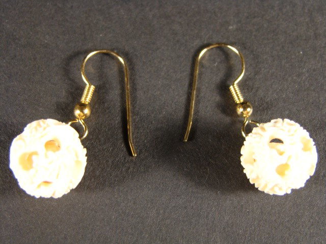 Very Rare Hand Carved Ivory Puzzle Ball Sphere Ear: This beautiful art is all hand carved from natural Mammoth Ivory. This is a carving of a Puzzle ball sphere shaped into an earring. It is rare and unique. Approx Size: Wide: 1/2 inch Diameter. About t