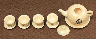 Mammoth Tusk Netsuke Miniature Antique Tea Set Car: 100% Genuine Mammoth ivory Miniature Chinese Antique Tea Set Carving.There is a Chinese Symbol which means "long life" scrimshawed on the surface of the Tea pot and each tea cup. This symbol always ca