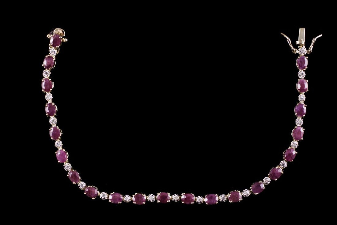 8 CT Ruby Diamond Bracelet Appraised $3,250: Master jewelers designed your bracelet with... 21 pieces of GENUINE 5X4mm faceted Ruby. 21 pieces of GENUINE single cut diamonds .14 carat tw. 12 grams of sterling silver layered with 18K Gold. The le