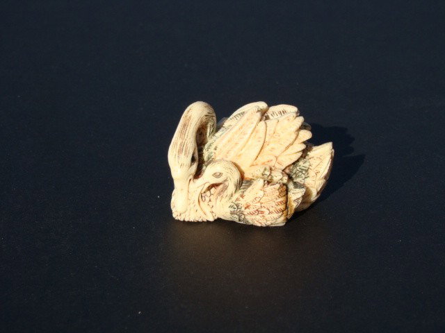 Rare Hand Carved Ivory Figurine Swan Feathers: This beautiful art is all hand carved from natural Mammoth Ivory. This is a carving of the swan rearing its duckling. It is rare and unique. Approx Size: Wide: 2 inch, High: 1 inch. About the Mammoth