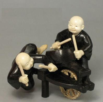 Mammoth Ivory & Ebony Iron Wood Happy Boy Playing Drum: 100% Genuine Mammoth ivory & Ebony Iron Wood handcrafted "Happy Boy Playing Drum" okimono carving, size: 3-1/4" x 2-5/8" x 2-3/4" (83mm x 67mm x 70mm). This okimono is carved by our artisan. The carvi