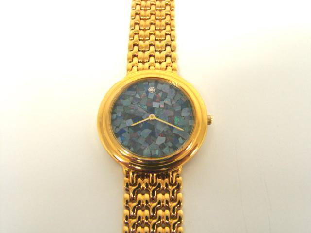 Genuine Opal Gold Watch: Master jewelers designed your watch with Opal face. 1 piece of GENUINE single cut diamond .01 carat tw. 35 grams of brass layered with 18K Gold.