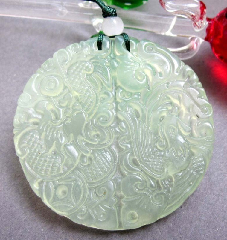 Green Jade Fortune Dragon Phoenix Amulet Pendant: The Royal Cameo Carving Jade Charm was carved from a piece of fine grained Jade gemstone more than 200 years ago. The design is unique and very lovely and the carving is delicately performed. Size: 27