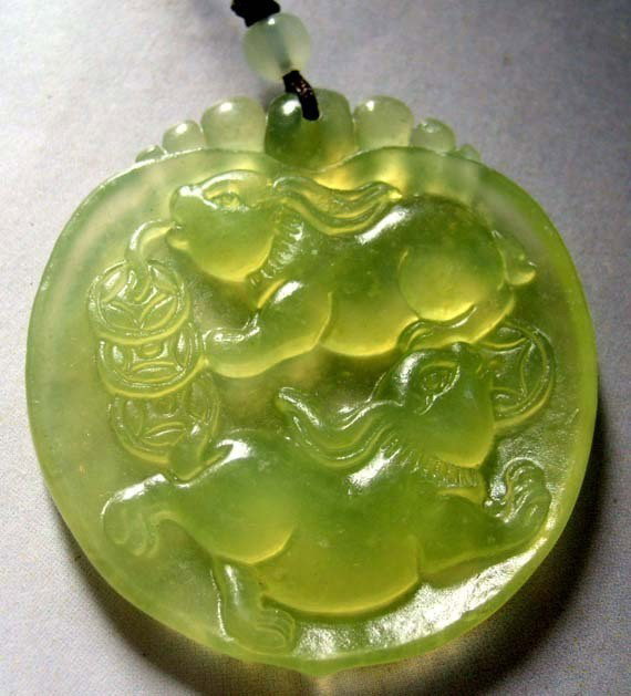 Green Jade Two Lucky Rabbits Coins Pendant: The Royal Cameo Carving Jade Charm was carved from a piece of fine grained Jade gemstone more than 200 years ago. The design is unique and very lovely and the carving is delicately performed. Size: 27