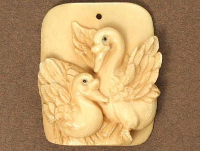 Rare and Unique Mammoth Ivory 2 Ducks Pendant: 100% Genuine Mammoth Ivory handcrafted 2 Ducks, size: 1-3/8" x 1-1/8" (35mm x 29mm). This pendant is carved from a material in natural ivory color. Our designer used this special feature of the materi