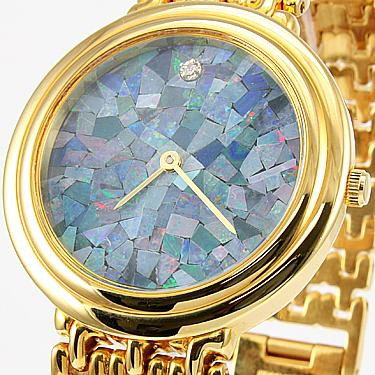Genuine Opal Face with Diamond Gold Watch: Master jewelers designed your watch with Opal face. 1 piece of GENUINE single cut diamond .01 carat tw. 35 grams of brass layered with 18K Gold.