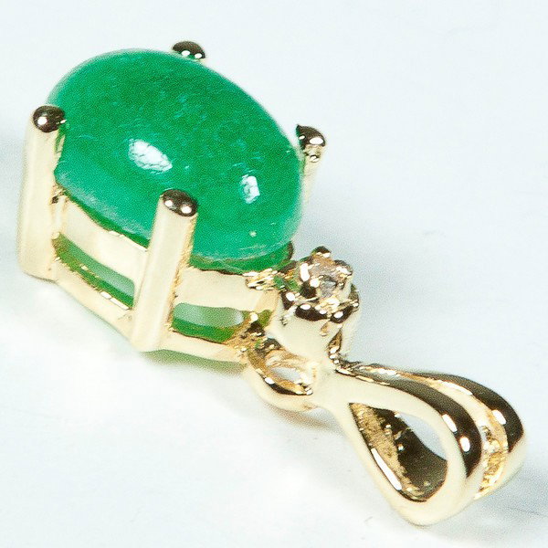 Genuine 1 1/2 CT Cabochon Emerald Diamond Pendant: Master jewelers designed your pendant with 1 piece of GENUINE 8X6mm oval GENUINE cabochon emerald. 1 piece of GENUINE single cut diamond .01 carat tw. 0.7 gram of brass layered with 18K Gold.