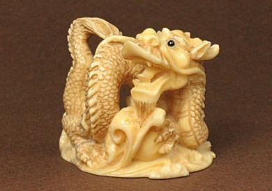 Hippo Tusk Ivory Netsuke POWERFUL DRAGON Carving: 100% Genuine Hippo Tusk Ivory handcrafted "Powerful Dragon" carving, size: 1-6/16" x 1-3/8" x 1-1/16".This carving is carved by our artisan. The carving is very detail and wonderful workmanship.