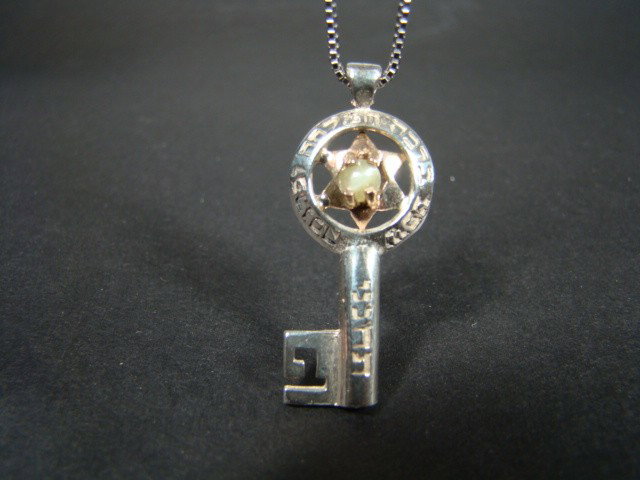 Kabbalah Jewelry Magen David Key Pendant: A Charm in a gold David´s key design with cherysoberyl insert. David´s Shield or The Star of David, as it is sometimes called, is a symbol of Protection.