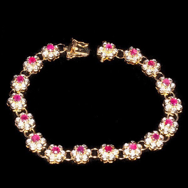 Genuine 9 CT Cabochon Ruby Diamond Bracelet: Master jewelers designed your bracelet with 16 pieces of GENUINE 5X4mm faceted oval cabochon rubies. 128 pieces of GENUINE single cut diamonds .9 carat tw. 17 grams of sterling silver layered with 18K