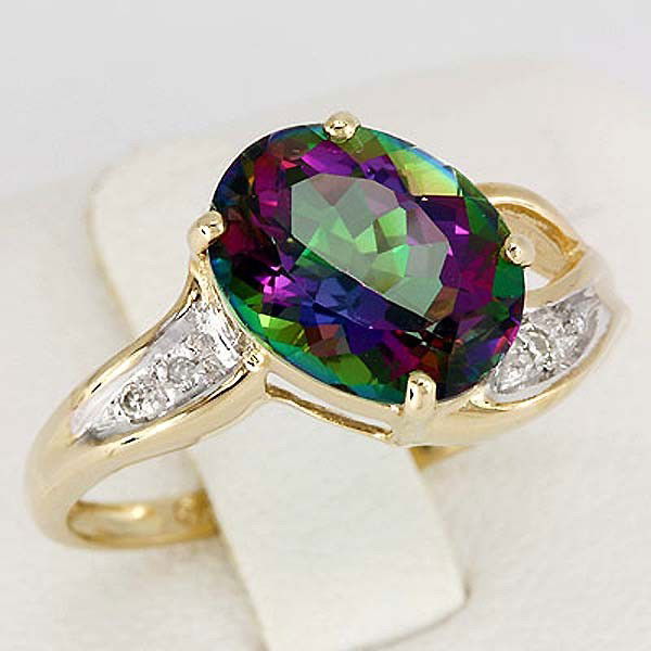 Genuine 3.11 Ct Mystic Topaz & Diamond $3,300: Mystic Topaz 3.11 ct. (Prong setting, Oval 10x8 mm = 1) Diamond 0.02 ct. (Pave setting, Round s/c 0.005 ct = 4) H-I diamond color, I1-I2 diamond clarity Size 7 ,yellow gold. Comes with certificate.