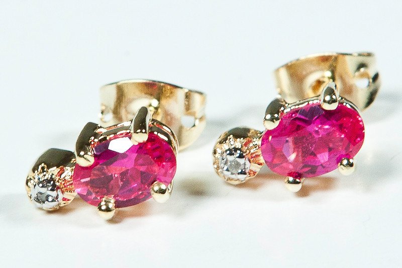 Genuine .85 CT Ruby Diamond Earrings: Master jewelers designed your earrings with 2 pieces of GENUINE 6X4mm faceted oval rubies. 2 pieces of GENUINE single cut diamonds .03 carat tw. 1.3 grams of sterling silver layered with 18K Gold. The