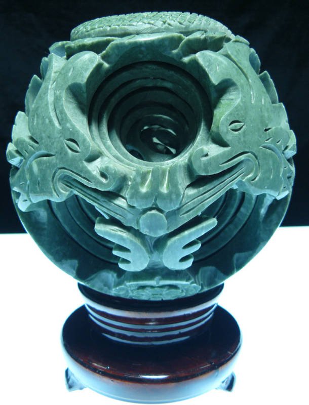 LARGE JADE 8 LAYER DRAGON PUZZLE BALL SPHERE: THIS WONDERFUL PIECE OF WORK IS MADE OF REAL JADE. IN ONE PIECE OF SOLID JADE, THERE ARE TOTAL OF 7 BALLS INSIDE. ALL BALLS INSIDE ARE MOVABLE INDIVIDUALLY. IT COMES WITH A WOODEN BASE. Size: Wide: 6"